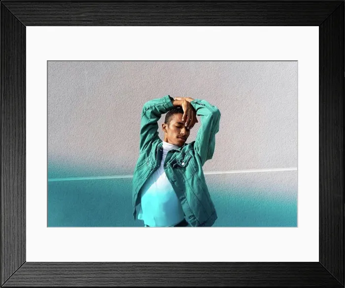 Framed Print : Man with eyes closed dancing while standing against multi colored wall Framed Print : Man with eyes closed dancing while standing against multi colored wall