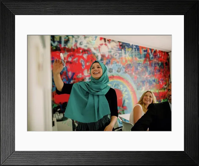 Framed Print : Smiling businesswoman wearing hijab in meeting at convention center Framed Print : Smiling businesswoman wearing hijab in meeting at convention center