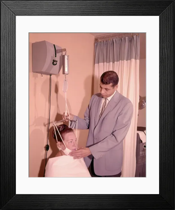 Framed Print : 1950s 1960s MAN TECHNICIAN ADJUSTING TENSION ON WOMAN PATIENT CHIN BRACE NECK TRACTION MEDICAL EQUIPMENT Framed Print : 1950s 1960s MAN TECHNICIAN ADJUSTING TENSION ON WOMAN PATIENT CHIN BRACE NECK TRACTION MEDICAL EQUIPMENT