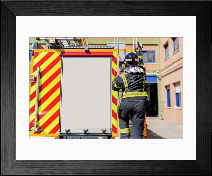 Framed Print : firefighter getting on the truck to work in emergency Framed Print : firefighter getting on the truck to work in emergency