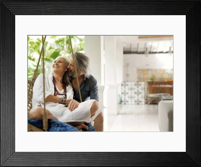 Framed Print : Senior man taking selfie at poolside while his wife is playing the guitar Framed Print : Senior man taking selfie at poolside while his wife is playing the guitar
