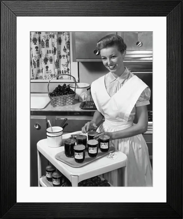 Framed Print : Young woman preparing jam in a kitchen