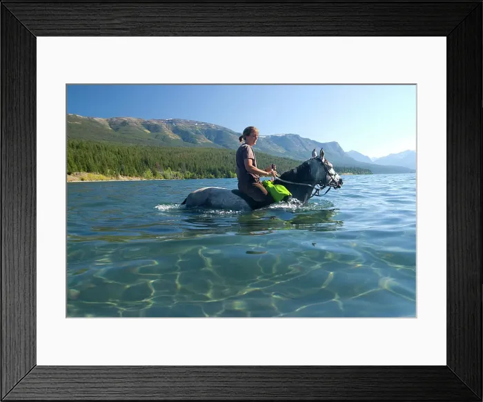 Framed Print : A young woman and her horse wade in the shallow, clear waters of Tatlayoko Lake, British Columbia, Canada Framed Print : A young woman and her horse wade in the shallow, clear waters of Tatlayoko Lake, British Columbia, Canada