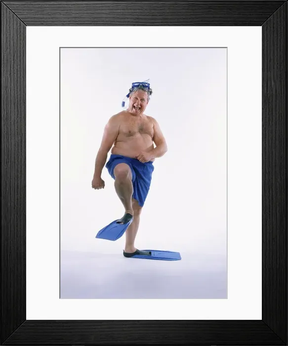 Framed Print : Portrait of a mid adult man in shorts wearing flippers with a mask and a snorkel Framed Print : Portrait of a mid adult man in shorts wearing flippers with a mask and a snorkel