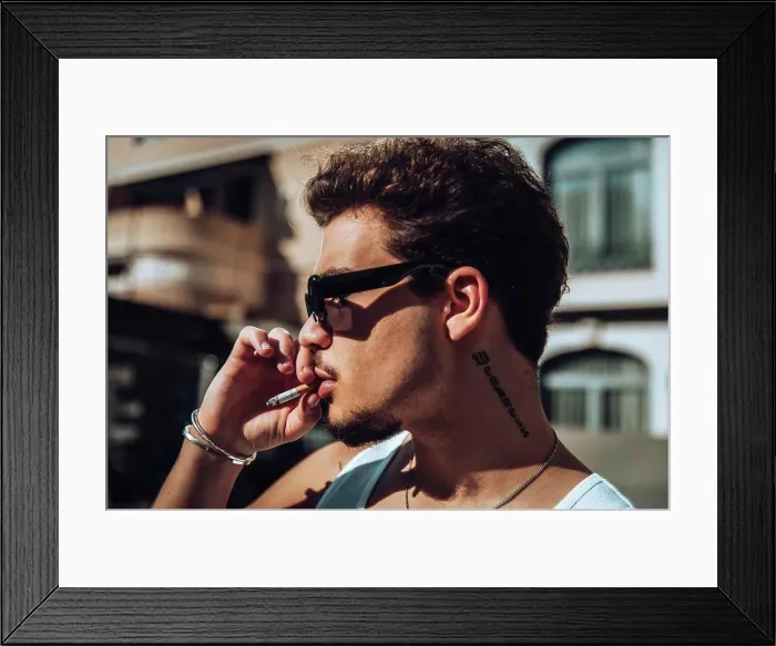Framed Print : Close-up of a tattooed guy with sunglasses smoking Framed Print : Close-up of a tattooed guy with sunglasses smoking