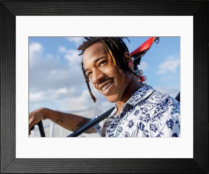 Framed Print : Smiling man looking away while carrying bicycle against sky Framed Print : Smiling man looking away while carrying bicycle against sky