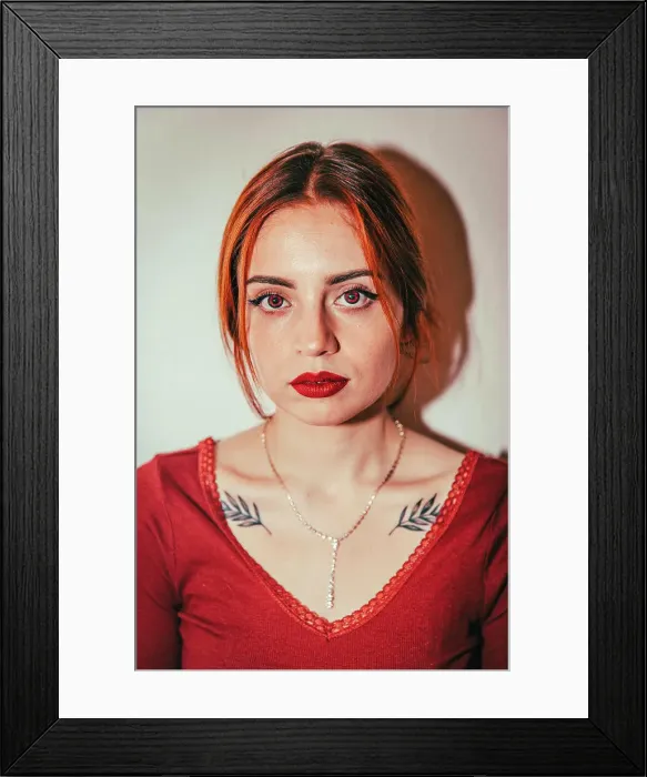 Framed Print : Portrait of a red-haired girl looking at the camera Framed Print : Portrait of a red-haired girl looking at the camera