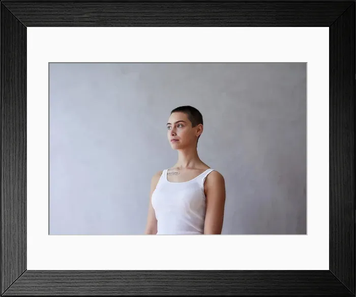 Framed Print : Portrait of short-haired young woman wearing vest Framed Print : Portrait of short-haired young woman wearing vest