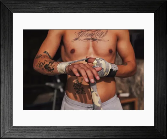 Framed Print : Boy putting bandages on his hands before a boxing match