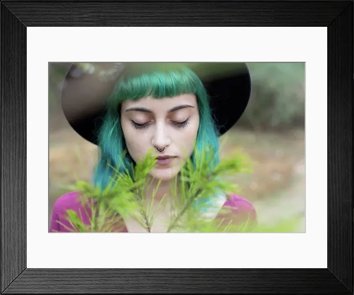 Framed Print : Portrait of young woman with dyed blue and green hair and nose piercing in nature