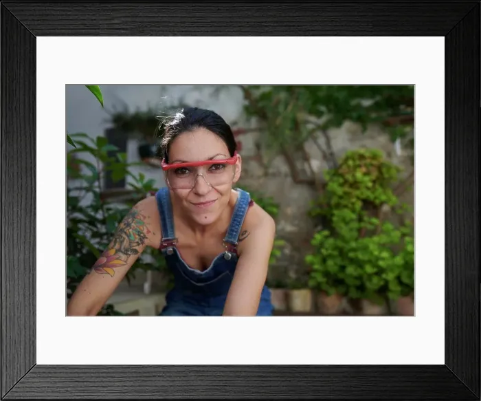 Framed Print : A smiling young woman with safety goggles looking at the camera Framed Print : A smiling young woman with safety goggles looking at the camera