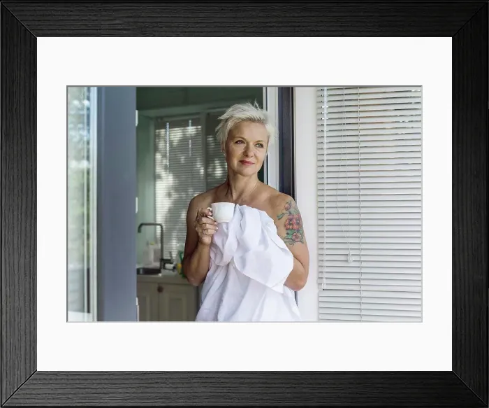 Framed Print : Woman with tattoo wrapped in sheet drinking coffee Framed Print : Woman with tattoo wrapped in sheet drinking coffee