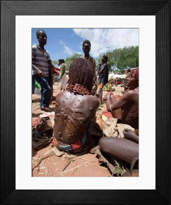 Framed Print : Hamar woman at market. Her scars result from ritual whipping which she undergoes to prove her devotion Framed Print : Hamar woman at market. Her scars result from ritual whipping which she undergoes to prove her devotion