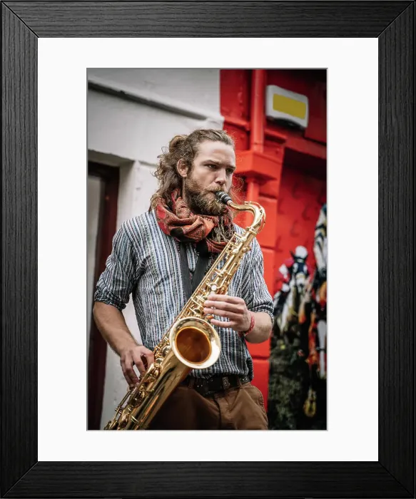 Framed Print : Male bearded and long haired saxophonist plays sax with bright emotions in the street Framed Print : Male bearded and long haired saxophonist plays sax with bright emotions in the street