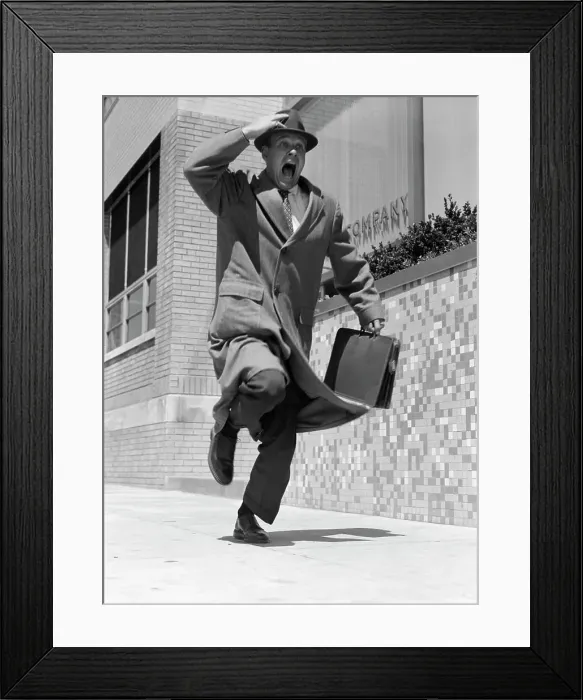 Framed Print : 1950S Frantic Man Running Down Street Holding Hat On With Hand Carrying Briefcase Wearing Top Coat Commuter Businessman Framed Print : 1950S Frantic Man Running Down Street Holding Hat On With Hand Carrying Briefcase Wearing Top Coat Commuter Businessman