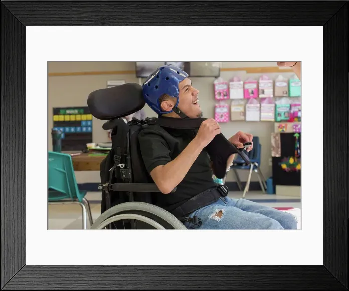 Framed Print : Boy with Spastic Quadriplegic Cerebral Palsy using using his special needs helmet Framed Print : Boy with Spastic Quadriplegic Cerebral Palsy using using his special needs helmet