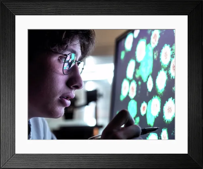 Framed Print : Male scientist researching on biological cell on computer screen in laboratory