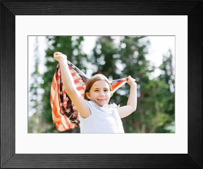 Framed Print : Girl (8-9) holding us flag in forest Framed Print : Girl (8-9) holding us flag in forest