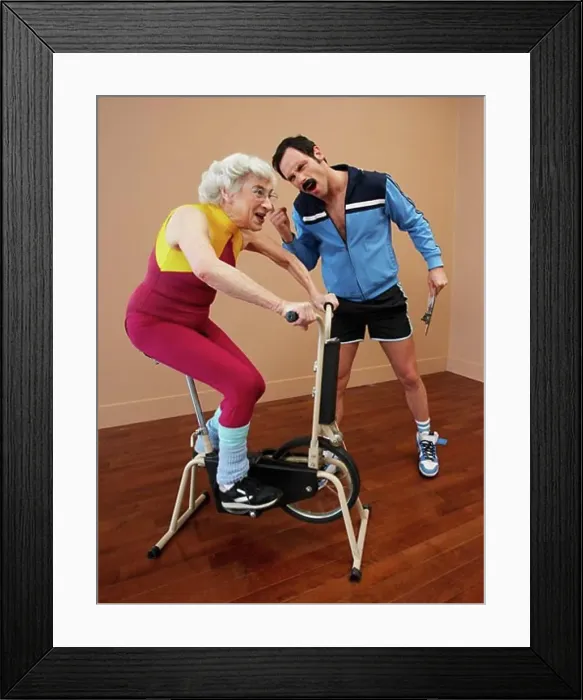 Framed Print : Personal Trainer Encouraging Woman on Exercise Bike Framed Print : Personal Trainer Encouraging Woman on Exercise Bike