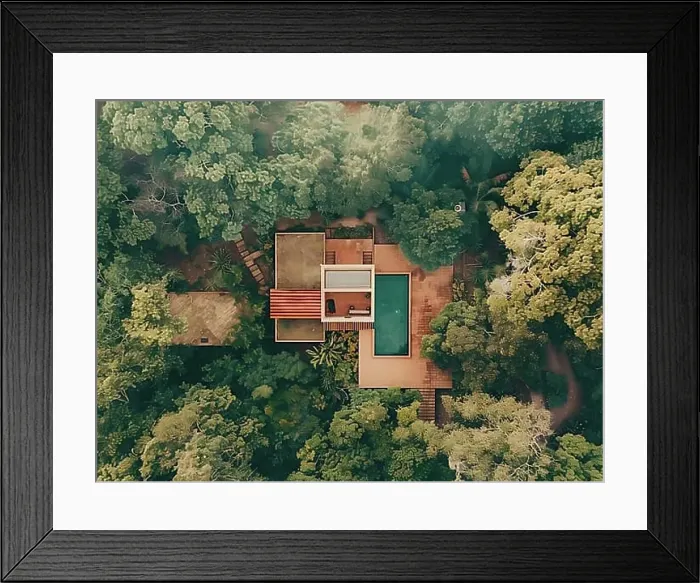 Framed Print : Aerial shot of a secluded house with a swimming pool surrounded by dense greenery