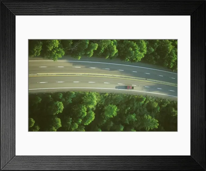Framed Print : Overhead shot of a vehicle on a four lane highway Framed Print : Overhead shot of a vehicle on a four lane highway