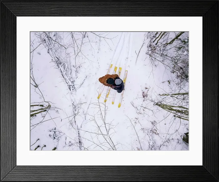 Framed Print : Aerial view of couple with skis in the forest, Leningrad region, Russia Framed Print : Aerial view of couple with skis in the forest, Leningrad region, Russia