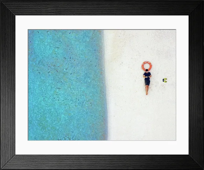 Framed Print : Mid adult male tourist lying with inflatable ring at tropical beach Framed Print : Mid adult male tourist lying with inflatable ring at tropical beach