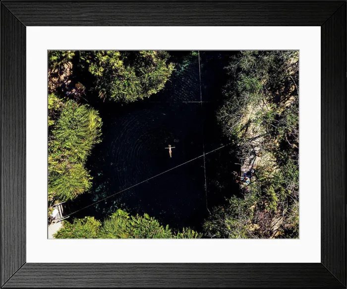 Framed Print : Aerial view of woman swimming in cenote Framed Print : Aerial view of woman swimming in cenote