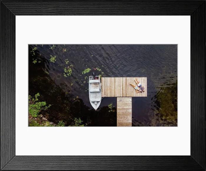 Framed Print : Overhead aerial image of couple laying on a dock together Framed Print : Overhead aerial image of couple laying on a dock together