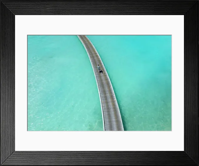 Framed Print : Aerial view of long man riding by bicycle on jetty in the sea Framed Print : Aerial view of long man riding by bicycle on jetty in the sea