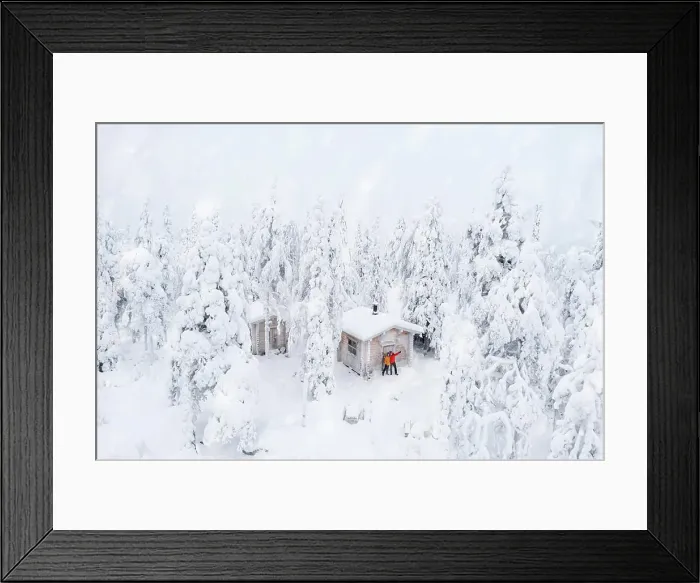 Framed Print : Aerial view of happy couple enjoying the winter holidays in a frozen hut in the snowy forest Framed Print : Aerial view of happy couple enjoying the winter holidays in a frozen hut in the snowy forest
