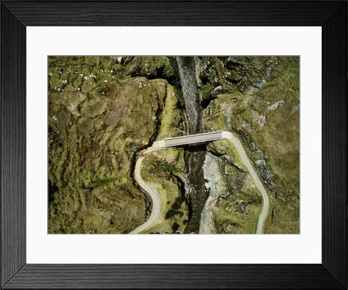 Framed Print : Aerial view of a solitary bridge over a mountain stream Framed Print : Aerial view of a solitary bridge over a mountain stream