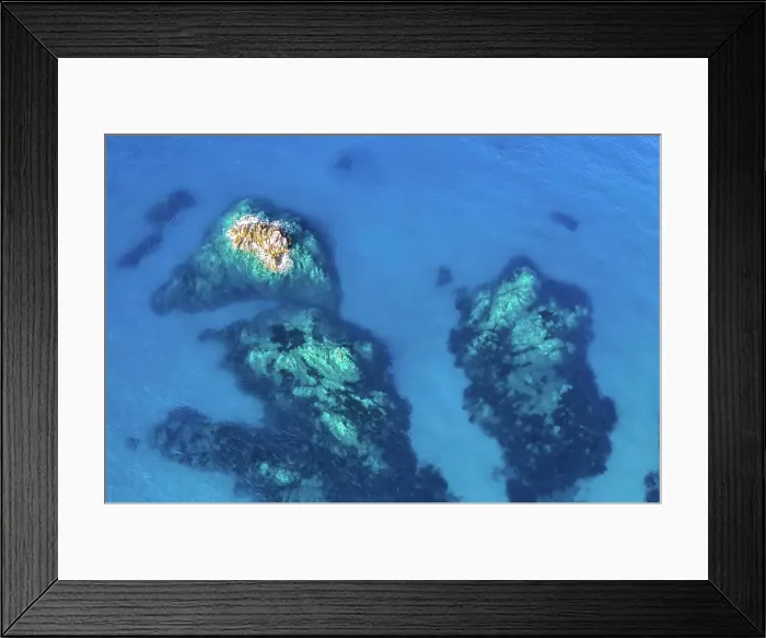 Framed Print : Aerial view of rocks beneath crystalclear blue waters Framed Print : Aerial view of rocks beneath crystalclear blue waters