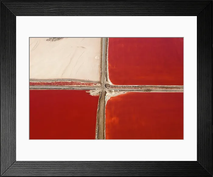 Framed Print : A striking aerial view of red salt ponds intersected by paths Framed Print : A striking aerial view of red salt ponds intersected by paths