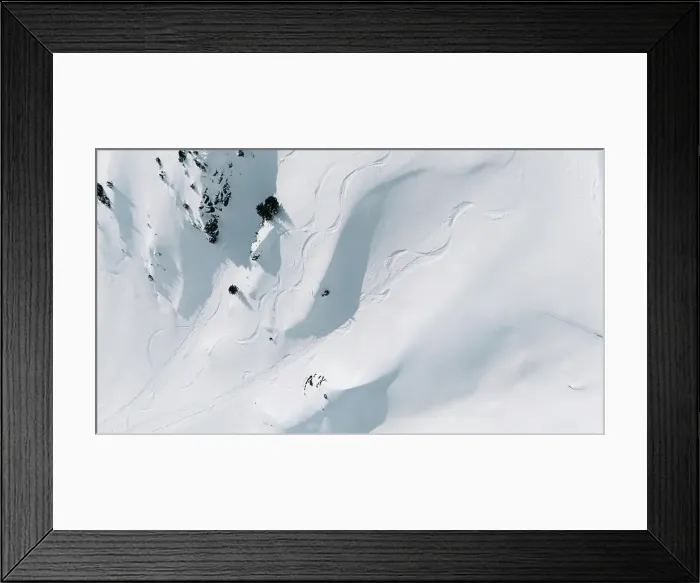 Framed Print : Aerial view of ski tracks and a freeskier on a snowy mountain slope Framed Print : Aerial view of ski tracks and a freeskier on a snowy mountain slope
