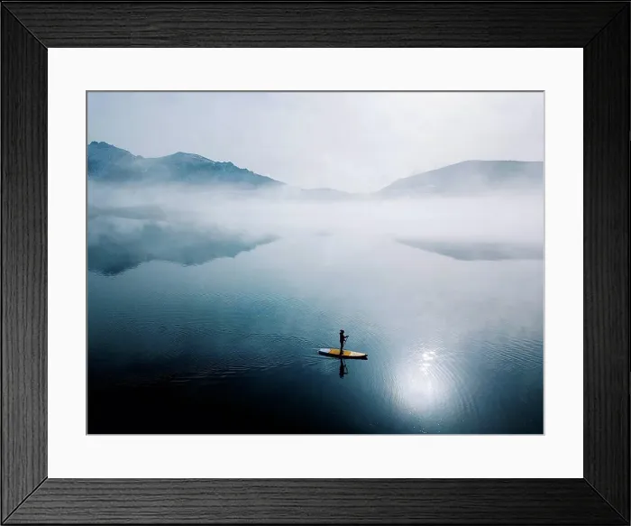 Framed Print : Aerial view of woman stand up paddle surfing, Leon, Spain Framed Print : Aerial view of woman stand up paddle surfing, Leon, Spain