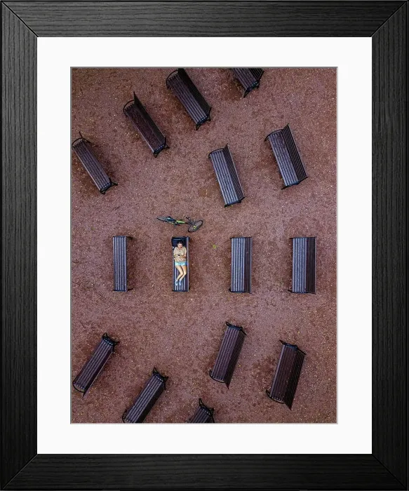 Framed Print : Aerial view of woman using smart phone while lying on bench in park Framed Print : Aerial view of woman using smart phone while lying on bench in park