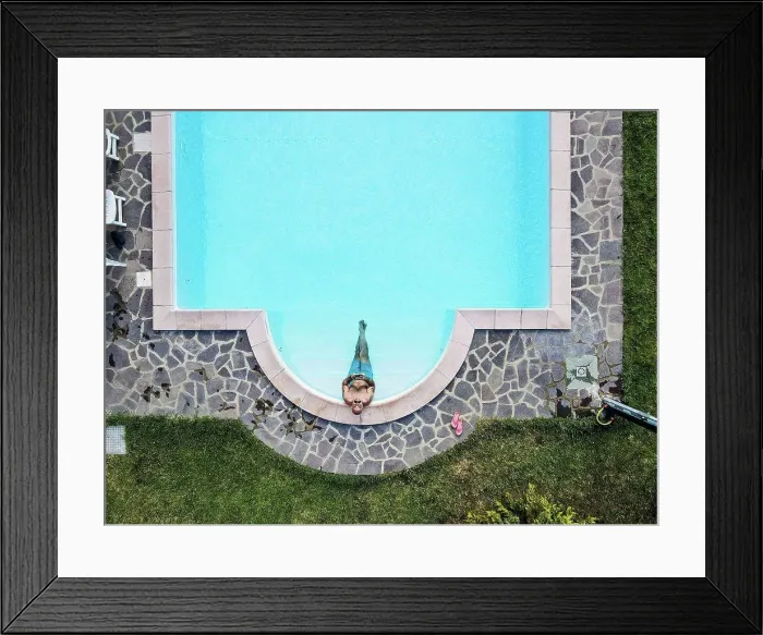 Framed Print : Drone view of man relaxing swimming pool Framed Print : Drone view of man relaxing swimming pool