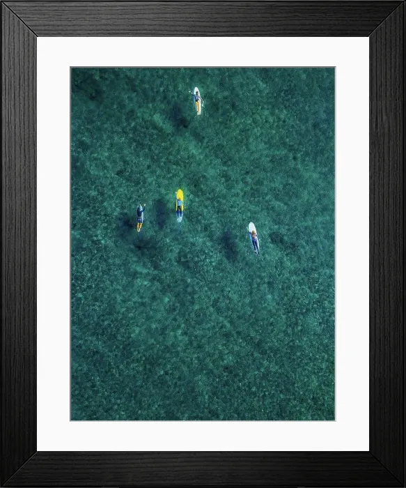 Framed Print : Aerial view of surfers swimming in turquoise waters of Arabian Sea Framed Print : Aerial view of surfers swimming in turquoise waters of Arabian Sea