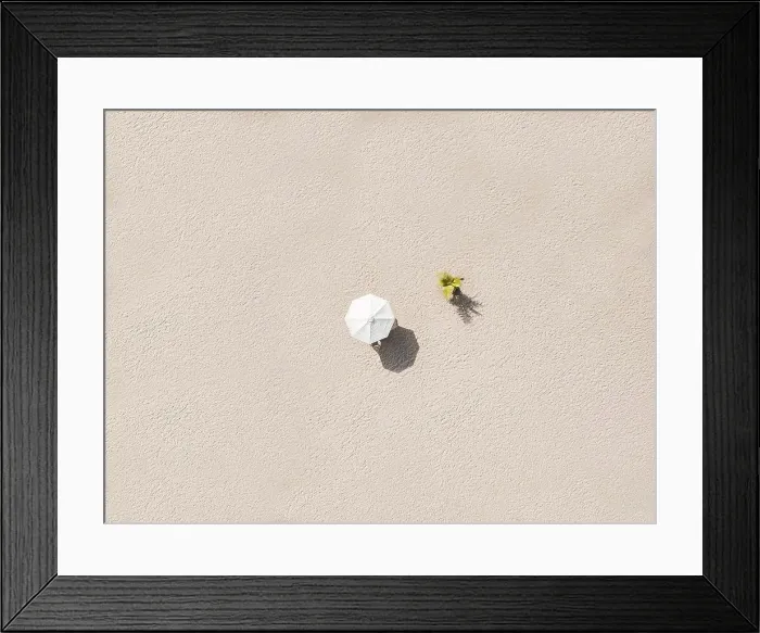 Framed Print : Aerial view of single beach umbrella on sandy beach