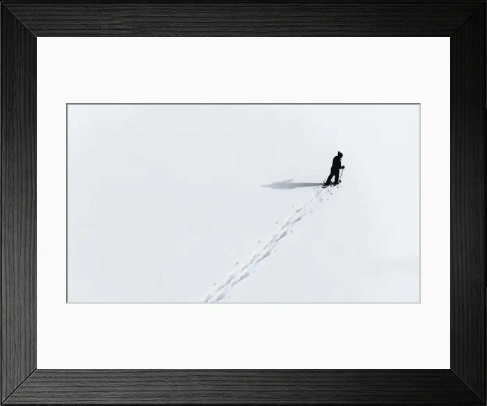 Framed Print : Aerial view of man snowshoeing across an empty snowy landcsape Framed Print : Aerial view of man snowshoeing across an empty snowy landcsape