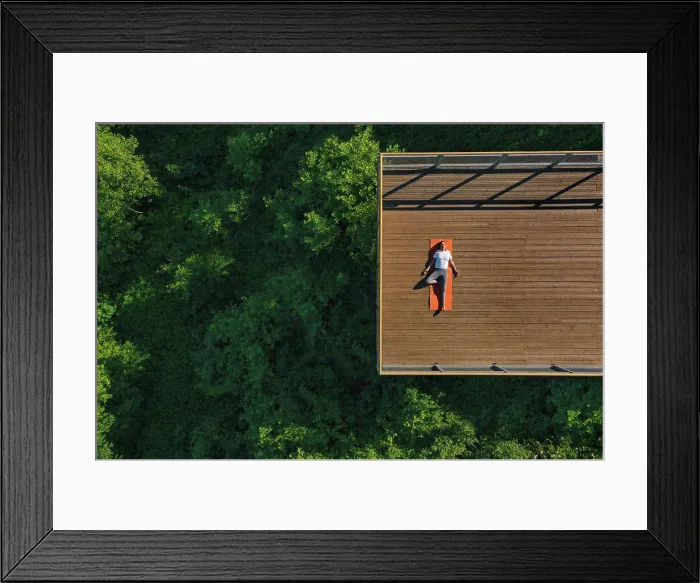 Framed Print : Young woman doing yoga on the balcony