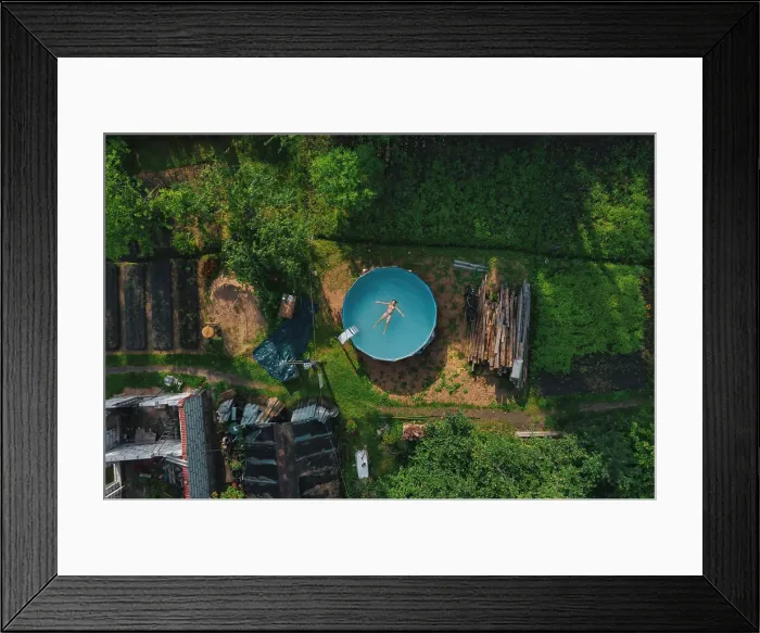 Framed Print : Aerial view of woman floating over water at pool Framed Print : Aerial view of woman floating over water at pool