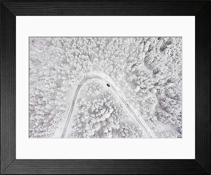 Framed Print : Car on road in winter trough a forest covered with snow Framed Print : Car on road in winter trough a forest covered with snow