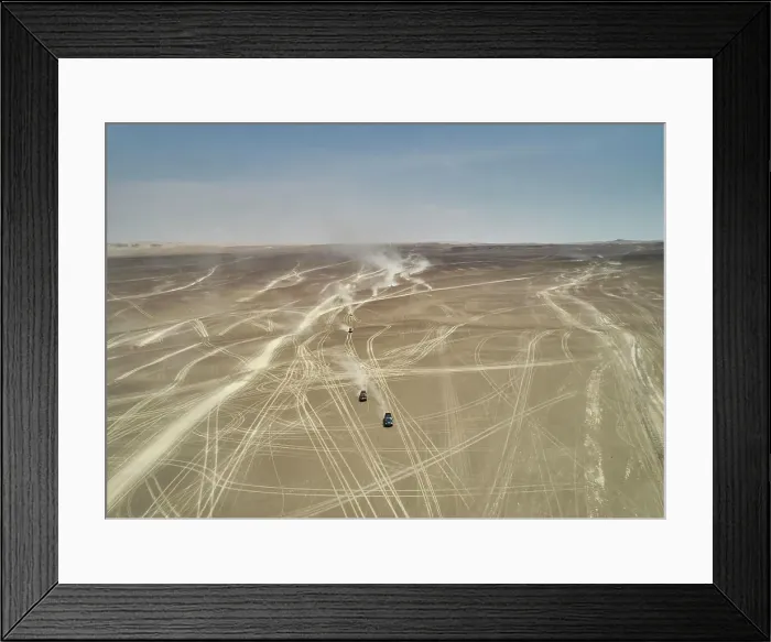 Framed Print : Aerial view of vehicular tracks crisscrossing a vast desert landscape