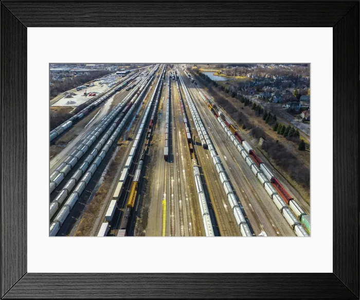 Framed Print : Aerial view of rail cars waiting at a staging railyard station in Aurora, IL - USA Framed Print : Aerial view of rail cars waiting at a staging railyard station in Aurora, IL - USA