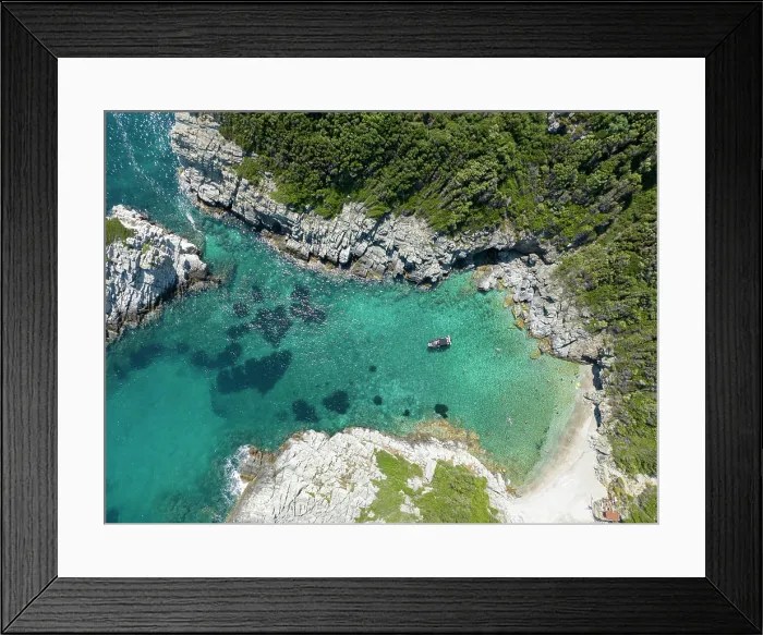 Framed Print : Tourists swim in a cove along the Greek Island of Skopelos Framed Print : Tourists swim in a cove along the Greek Island of Skopelos