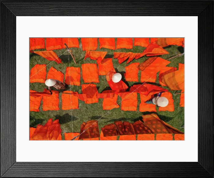 Framed Print : Aerial view of woman working in a public laundry drying red cloth in Araihazar, Dhaka, Bangladesh Framed Print : Aerial view of woman working in a public laundry drying red cloth in Araihazar, Dhaka, Bangladesh