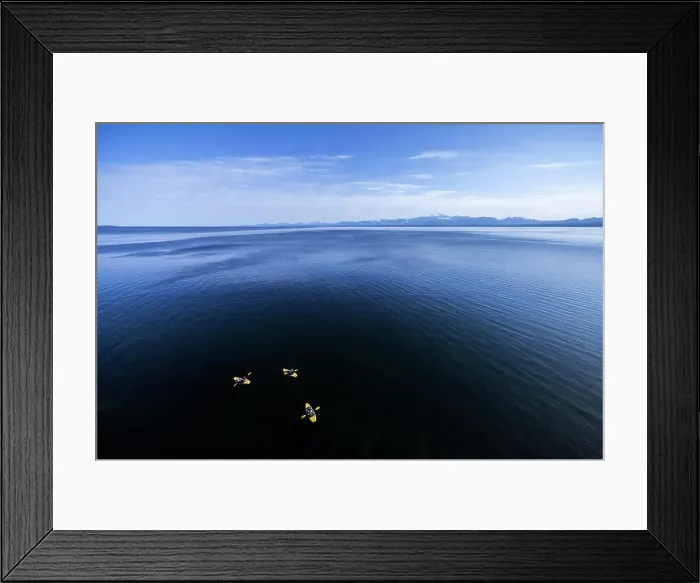 Framed Print : Kayakers skirt along the shoreline Framed Print : Kayakers skirt along the shoreline