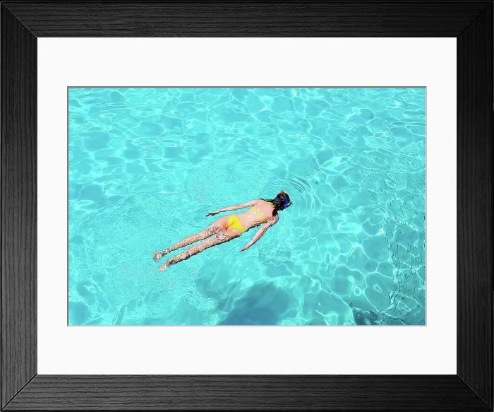Framed Print : Woman snorkeling in crystal clear turquoise water at tropical beach Framed Print : Woman snorkeling in crystal clear turquoise water at tropical beach
